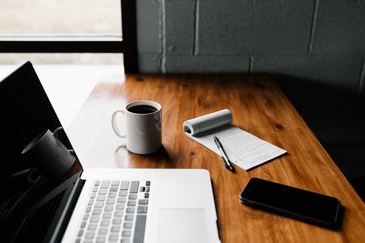 Content creator workspace with laptop and notebook